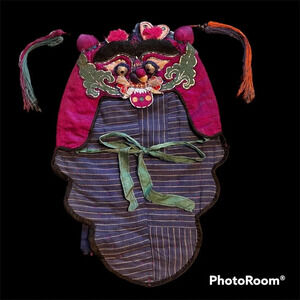 Antique vintage Asian child’s embroidered hat. Festival celebration festival